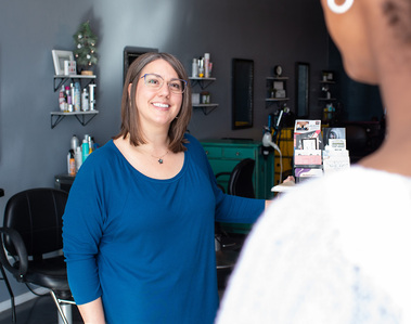 hair salon receptionist greets a customer in the salon at a brand photo session in Tuttle, Oklahoma