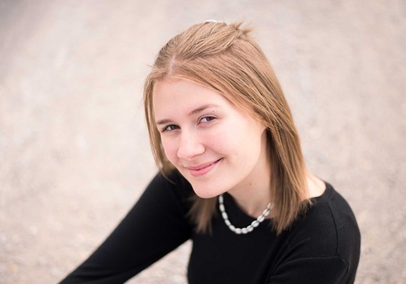 Portrait of a senior teenage girl smiling slightly at the camera