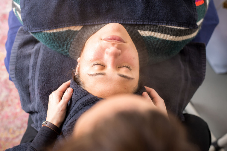 overhead shot of an aesthetician prepping her client for a facial while she lays on her table at a personal branding session at a salon in Moore, Oklahoma