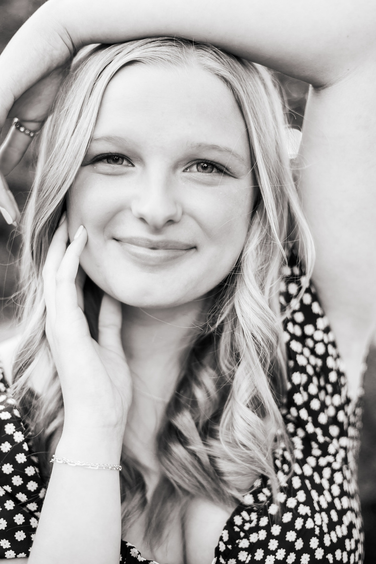 close up black and white image of a blond high school senior girl wearing a dress in a high fashion pose in downtown Oklahoma City