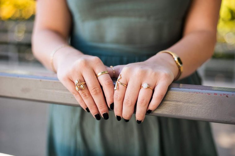 close up photo of a high school senior girl's hands and jewelry at Myriad Gardens in downtown Oklahoma City for senior portraits