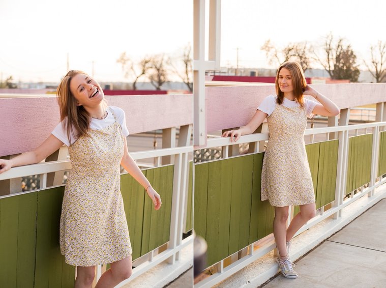 two photos of a high school senior girl stands in front of a green fence with white trim at the Classen inn in midtown Oklahoma City laughing and with her hand in her hair wearing a yellow dress