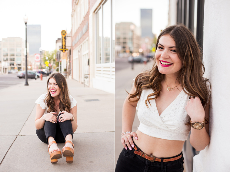 two photos of a high school senior girl with long brown hair wearing a white crop top and black jeans sitting and standing on the sidewalk in Automobile Alley in Oklahoma City, Oklahoma