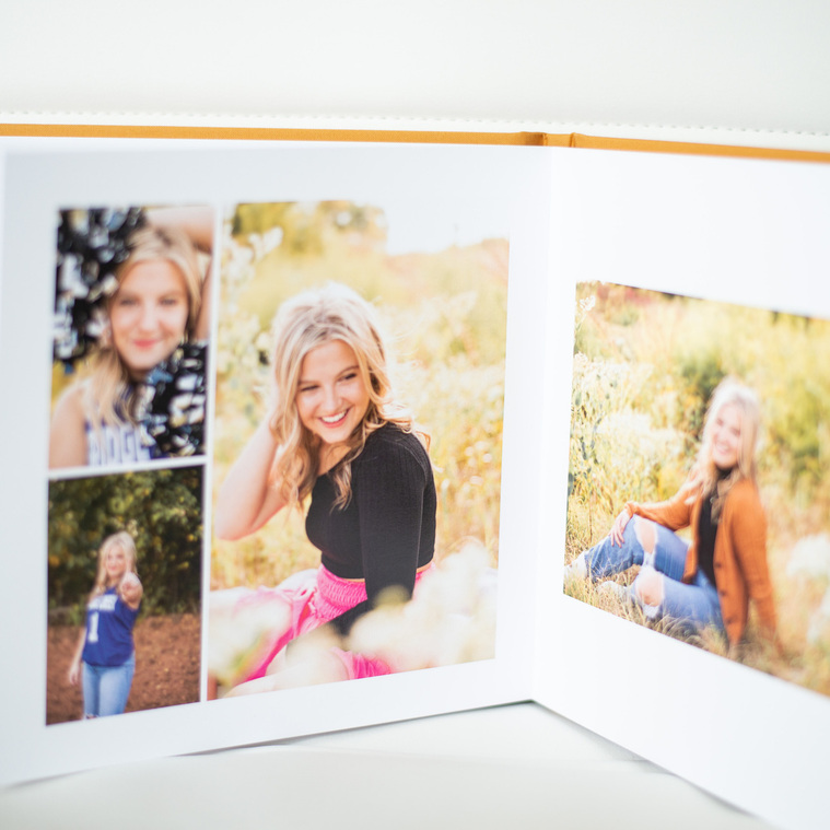 picture of an open hardcover photo book album with multiple senior photo images arranged in a layout