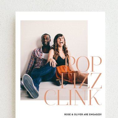 photo of a custom engagement announcement card with an engagement photo of a mixed race couple sitting together on the front
