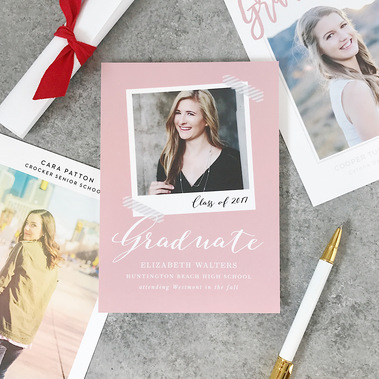 photo of 3 custom graduation announcement cards with senior photos on them surrounded by a diploma and pen