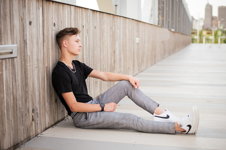 Headshots and portraits of a teen boy in downtown Oklahoma City. Scissortail Park and Parking Garage Rooftop with OKC skyline in background.