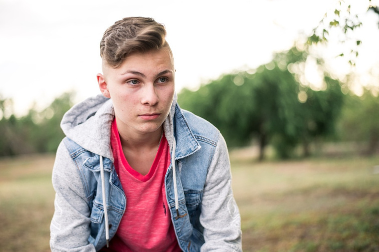 Teen boy posing casually in a park in Tuttle Oklahoma