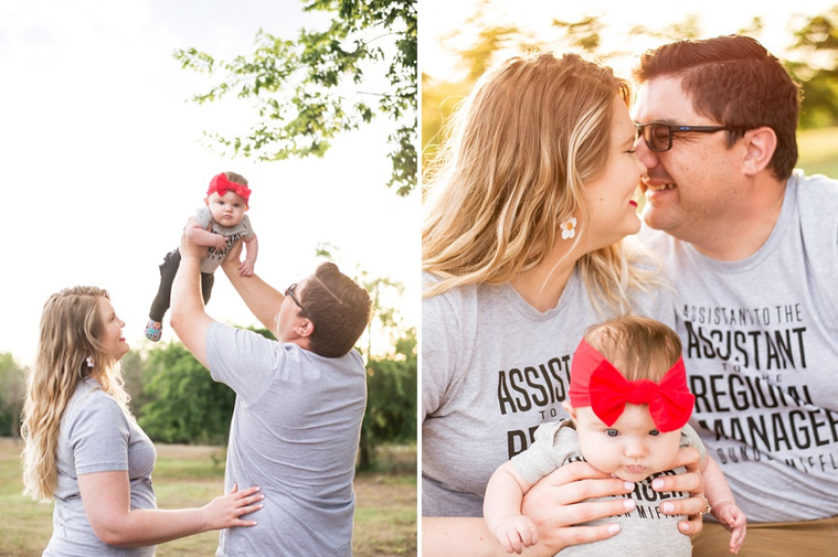 Mom and Dad hold their baby girl in the park wearing 
