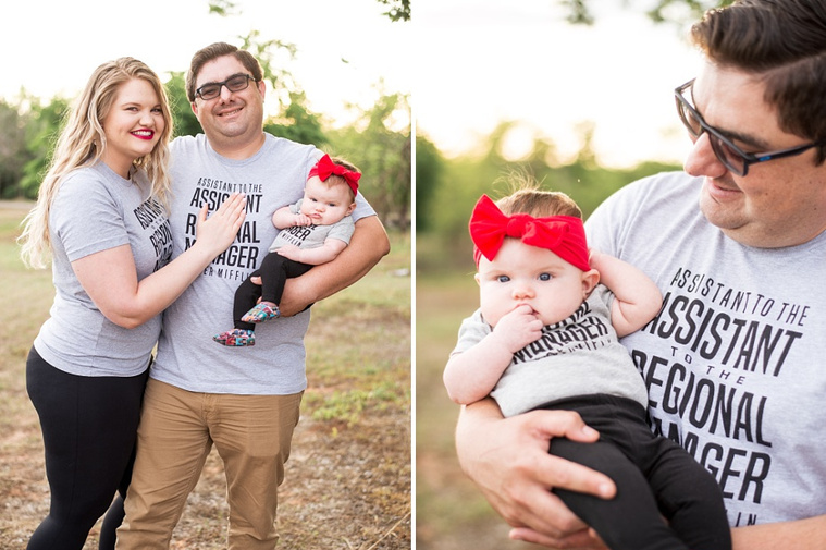 Mom and Dad hold their baby girl in the park wearing 