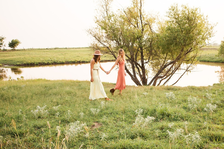 A mom and teen daughter dressed in boho in front of a field and pond in the country in Oklahoma