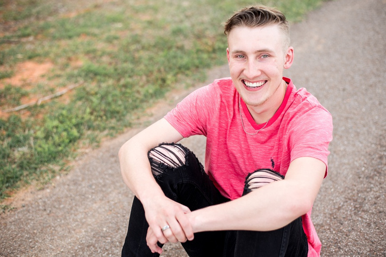 Teen boy posing casually on the walking path in a park in Tuttle Oklahoma