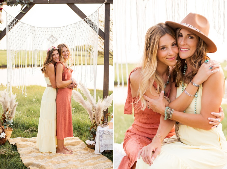 A mom and teen daughter dressed in boho style pose in front of boho decorations and a field and pond in the country in Oklahoma