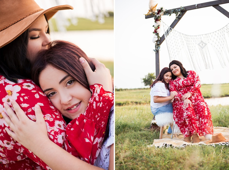 A mom and teen daughter dressed in boho style pose in front of boho decorations and a field and pond in the country in Oklahoma