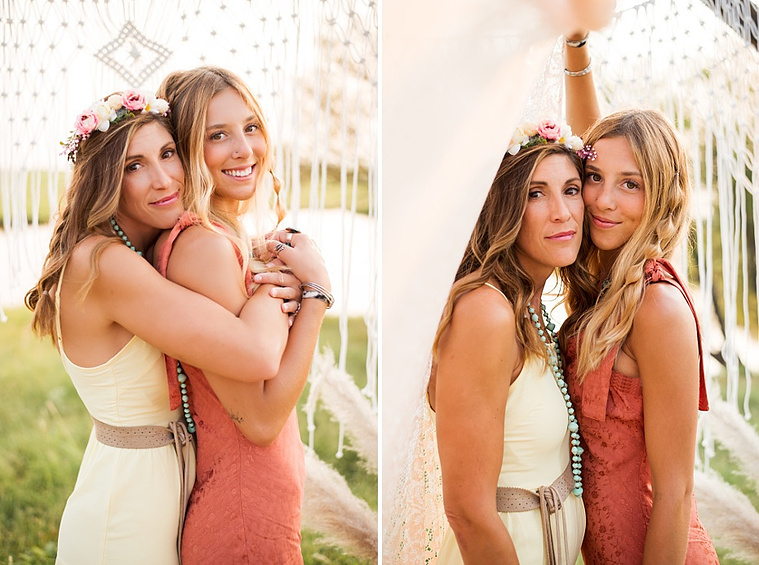 A mom and teen daughter dressed in boho style pose in front of boho decorations and a field and pond in the country in Oklahoma