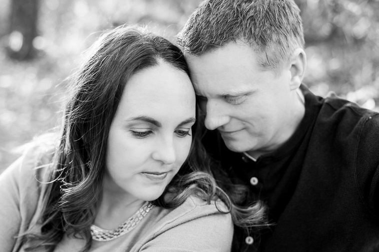 close-up black and white portrait of a husband and wife with their faces close together and having a moment to remember their love at a family photo session in Moore, Oklahoma