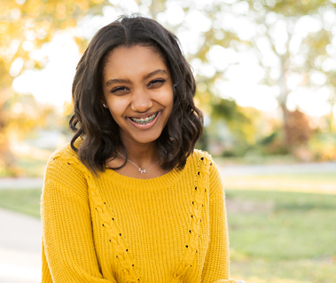 senior girl poses naturally and smiles at Will Rogers Park in Oklahoma City, Oklahoma at a fall photo mini session by Cheryl Jackson Photography