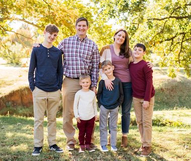 a family of 6 stand together and smile at Will Rogers Park in Oklahoma City, Oklahoma at a fall photo mini session by Cheryl Jackson Photography