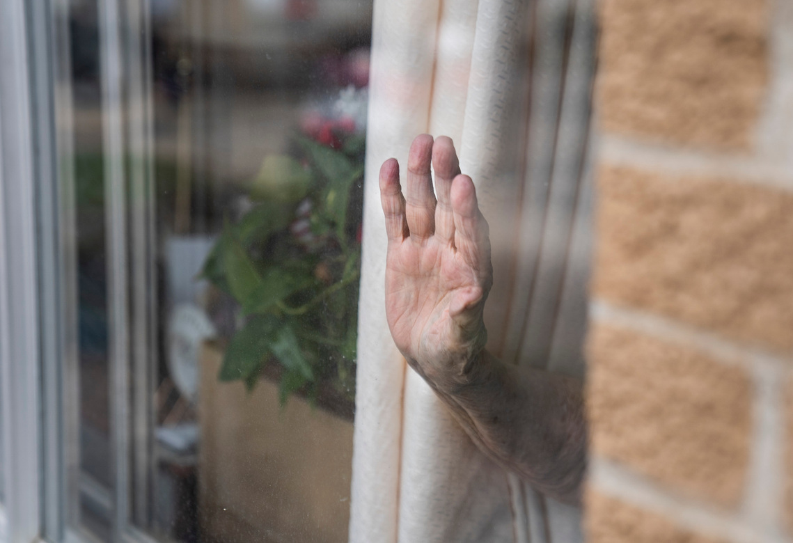A Spring Valley Resident waves through their window as Carr’s Clubhouse daycare visits with residents through the windows during their lockdown to help stop the spread of COVID-19 on Thursday, April, 2, 2020, at the center in Spring Valley, Minnesota. 
