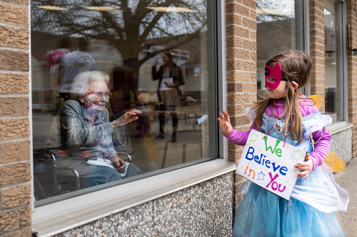 Kimber Zimmer, 3, waves goodbye to Spring Valley Resident Maxine Jahn while visiting the residents through the windows during their lockdown to help stop the spread of COVID-19 on Thursday, April, 2, 2020, at the center in Spring Valley, Minnesota. 