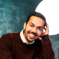 man casual in sweater smiling. 
