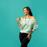 Image shows Isabel De Montiel with hands on aqua blue background. Isabel De Montiel is Atlas Studios preferred image stylist and consultant. 