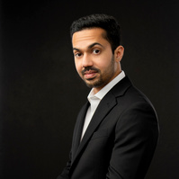 Men in suit smiling at camera. 