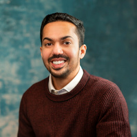 man casual in sweater smiling. 