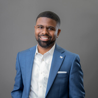 Man in blue suite on gray background. Clothing styling by Image Concepts.