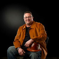 Man in brown leather jacket. Clothing styling by Image Concepts.