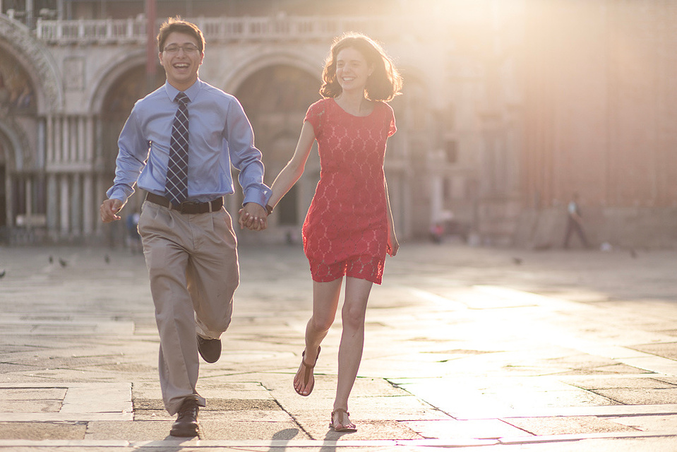 couple running at sunrise in st marks' square , Venice