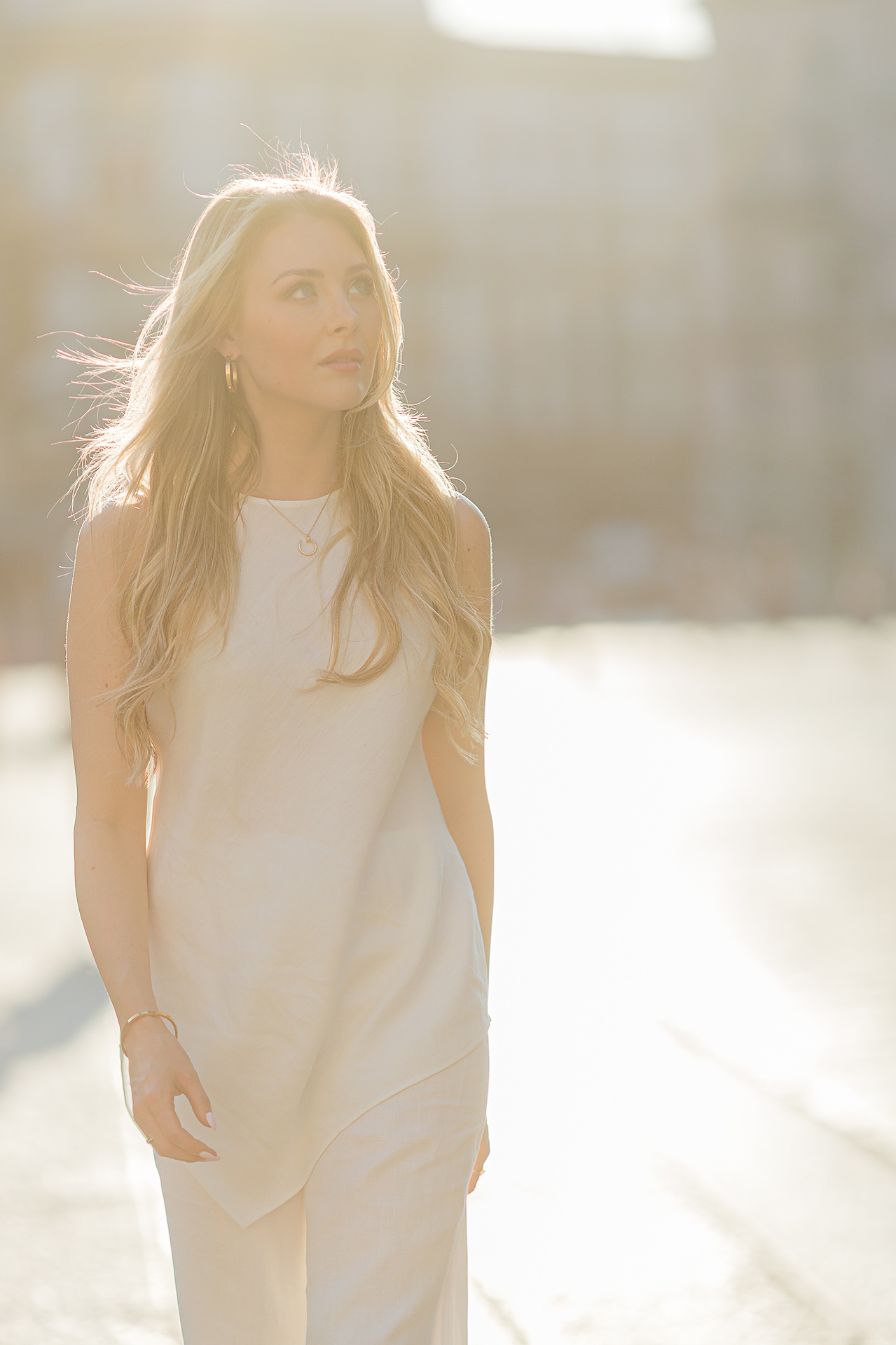dressed in white and wrapped by sunset light in Milan