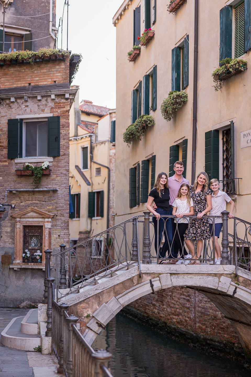 family on a quiet venetian bridge