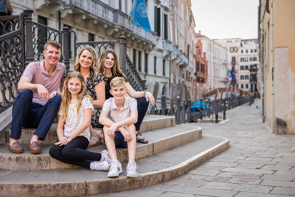 family of 5 in Venice on the staircase of a bridge in a scenic but off the beaten path location