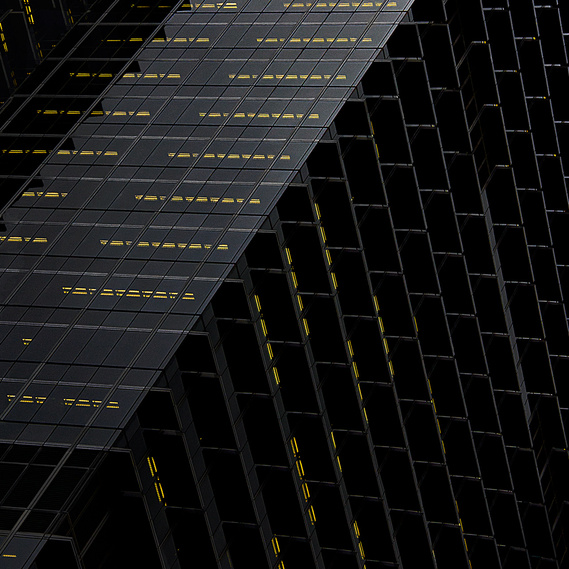 Black building with streaks of yellow neon lights