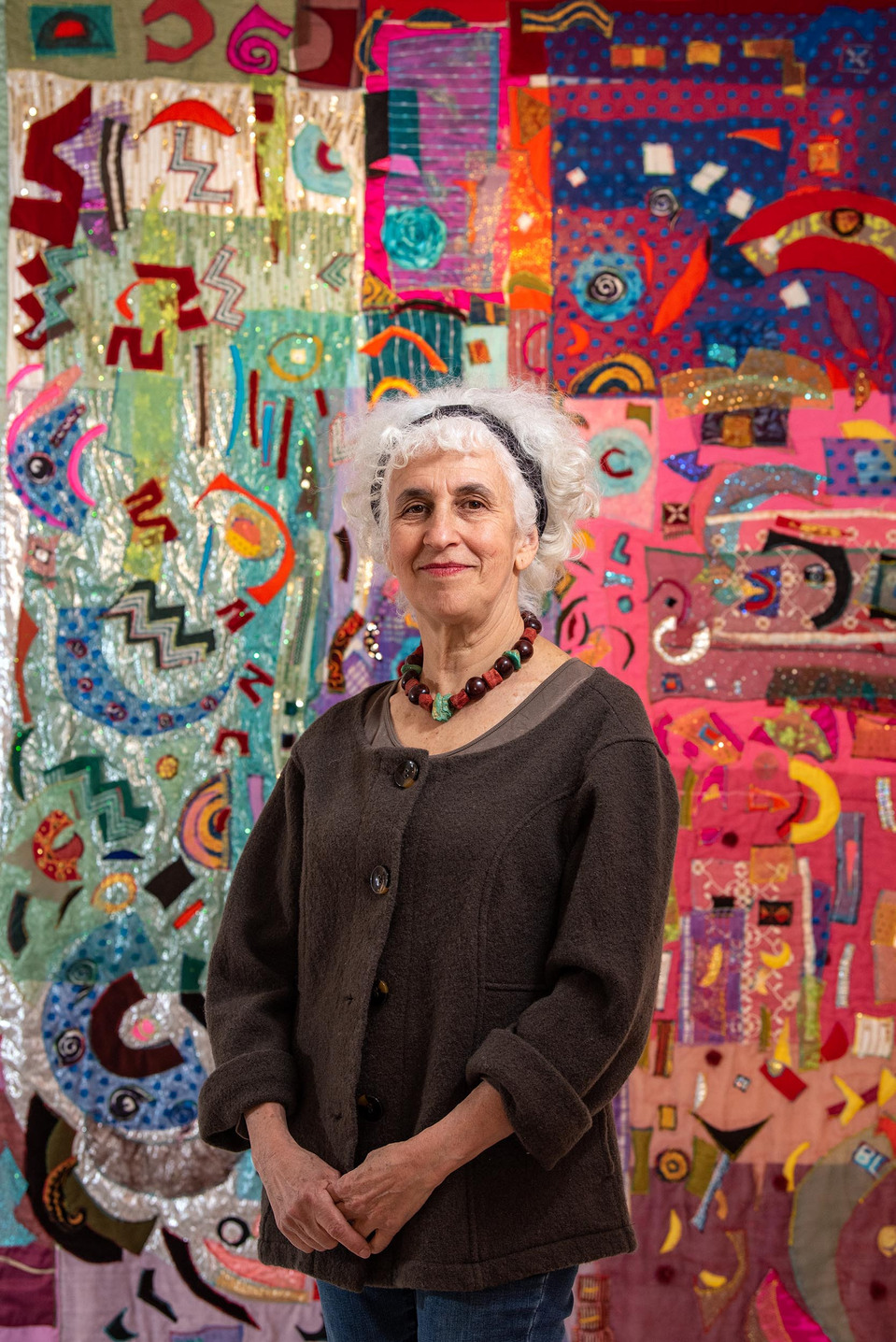 Textile artist Sheree Rasmussen stands in front of one of her artworks, entitled Messages from Above, in Castleton, Ont. Photo by Alex Lupul
