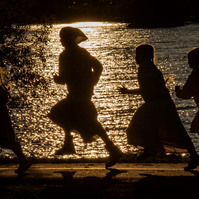 BELLEVILLE, Ont. (17/10/21) - Children are photographed in silhouette while running past the setting sun at West Zwick's Park in Belleville, Ont. on Oct. 17. Photo by Alex Lupul