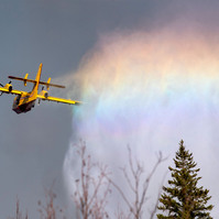 WHITESHELL, Man. (12/05/21) - A rainbow appears in the water dropped from an aircraft by the Manitoba Wildfire Service onto on a large forest fire south of Whiteshell Provincial Park on May 12, 2021. Photo by Alex Lupul