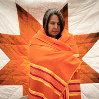 WINNIPEG, Man. (12/08/21) - Stephanie Scott, Executive Director at NCTR, is brought to tears after being wrapped in a shawl and a star blanket during a blessing at the future home of the National Centre for Truth and Reconciliation in Winnipeg on Aug. 12.