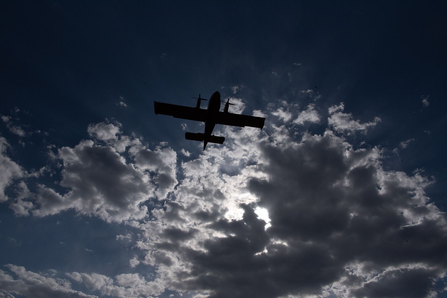 A plane drops water onto a forest fire in Manitoba.