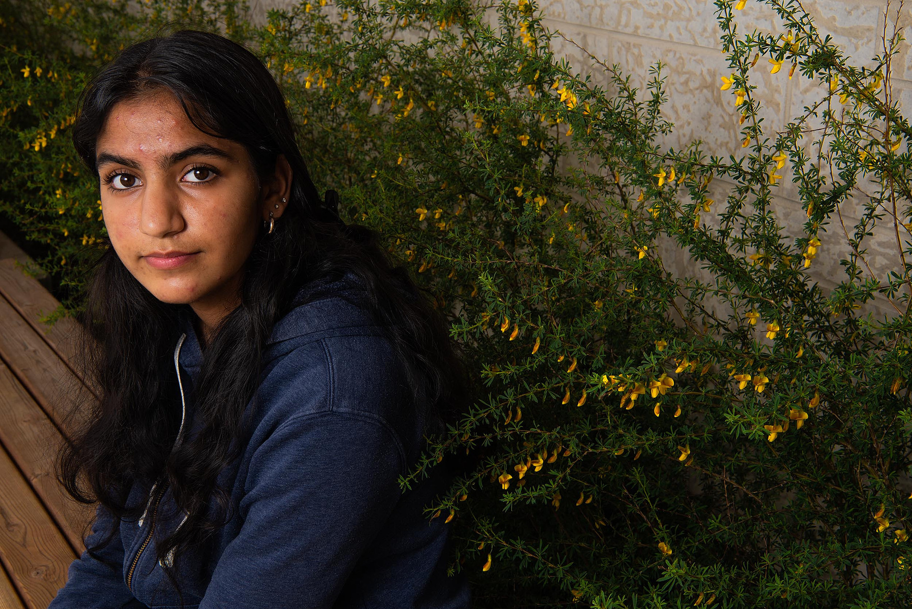 Winnipeg high school student Anantjot Khosa is photographed in front of flowers.