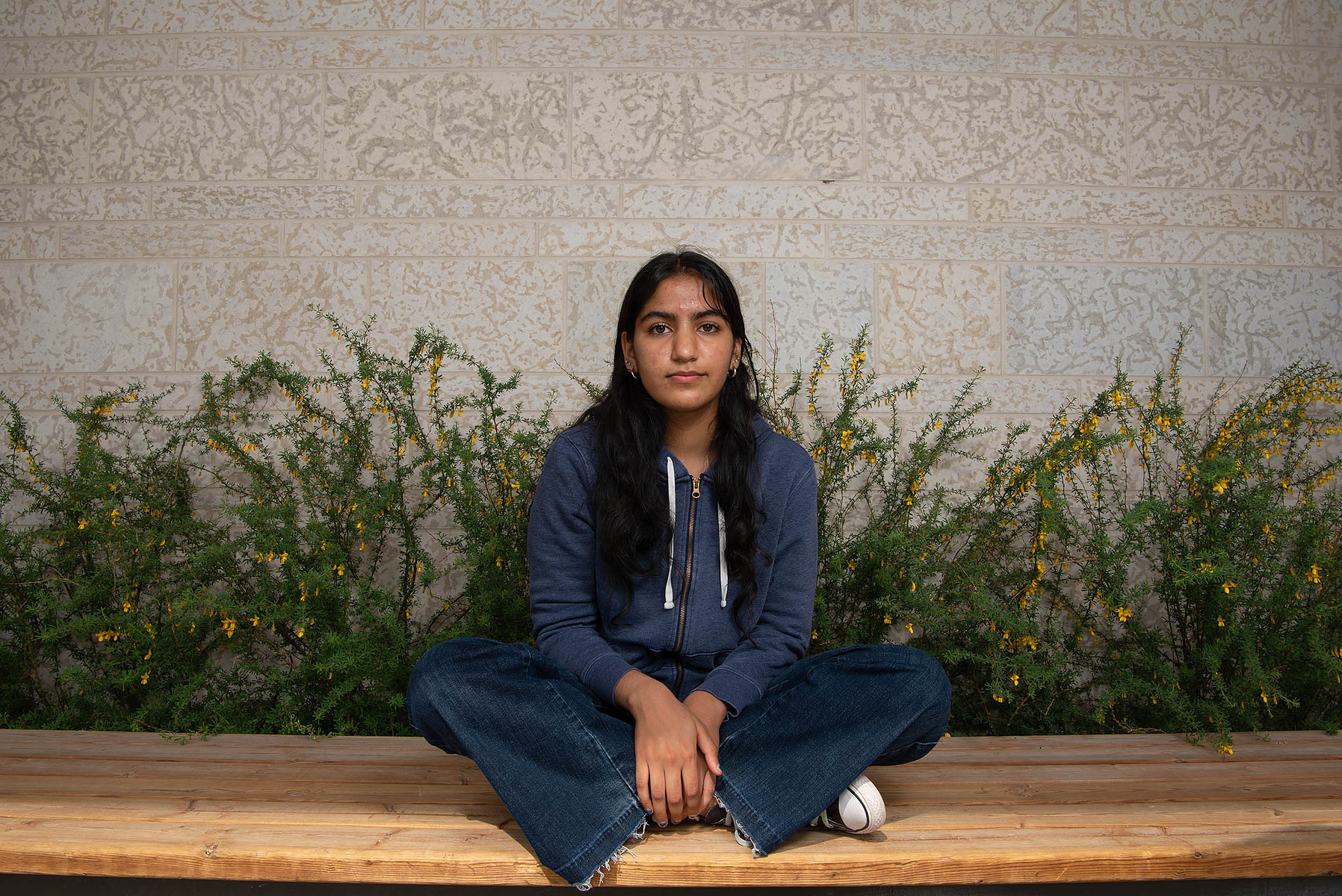 Winnipeg high school student Anantjot Khosa is photographed in front of flowers.
