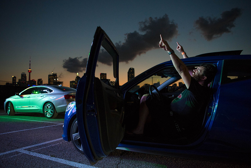 A man sings along from his car during an outdoor drive-in concert in Toronto.