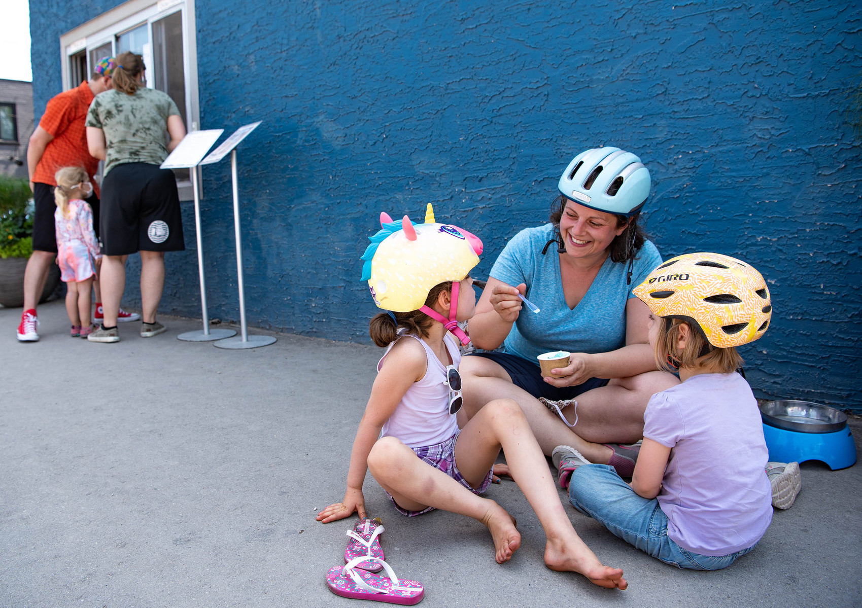 Sophie, Lynn and Lucy Campbell enjoy ice cream during the Tour de Glace, a 20-kilometre recreational event which makes stops at four local ice cream shops, outside of Dug & Betty's Ice Creamery in Winnipeg on July 24, 2021.