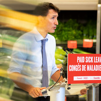 Food is seen reflected on a plexiglass shield while Liberal Leader Justin Trudeau speaks during a campaign stop at the Cavalier Drive FoodFare location in Winnipeg on Aug. 20, 2021.