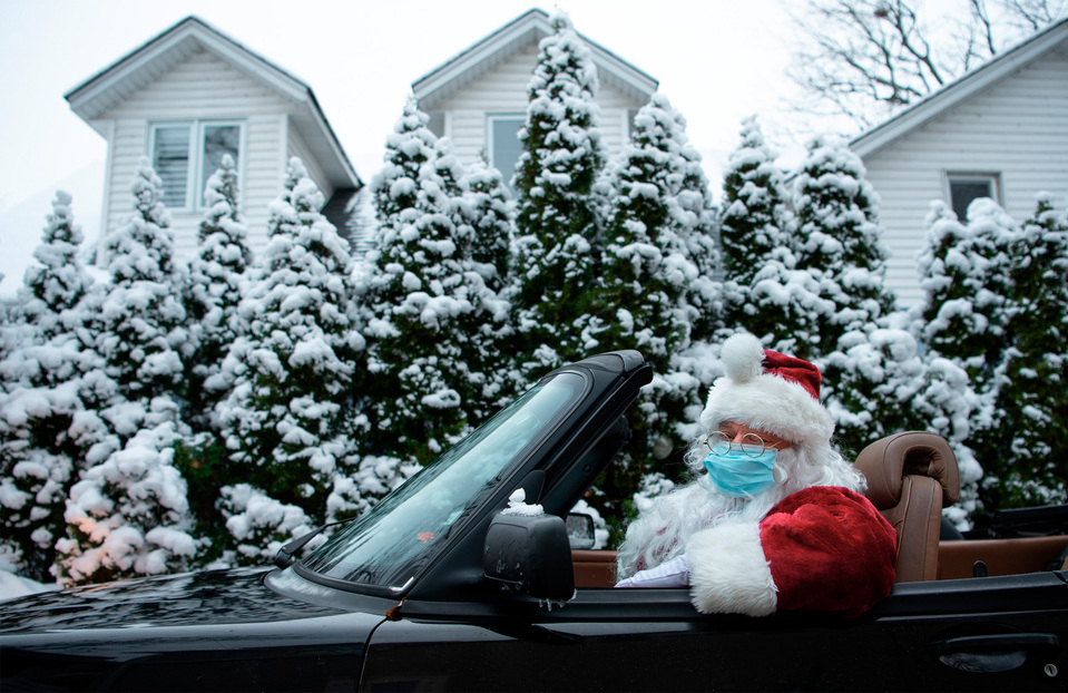 Sam Baio, founder of the charity Socks for Change, sits in his convertible outside of his St. Catharines home while dressed as Santa Claus on Christmas Day. Photo by Alex Lupul