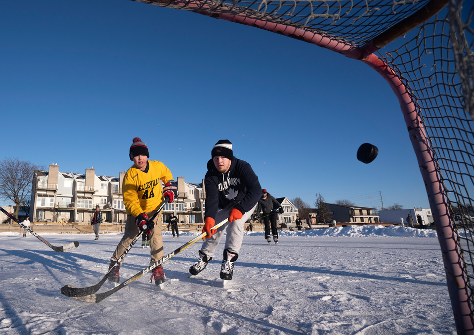 Carson McNulty scores a goal despite the defence of Bradly Drinkle while playing hockey on the frozen Victoria Harbour in Belleville, Ont. on Jan. 30. Photo by Alex Lupul