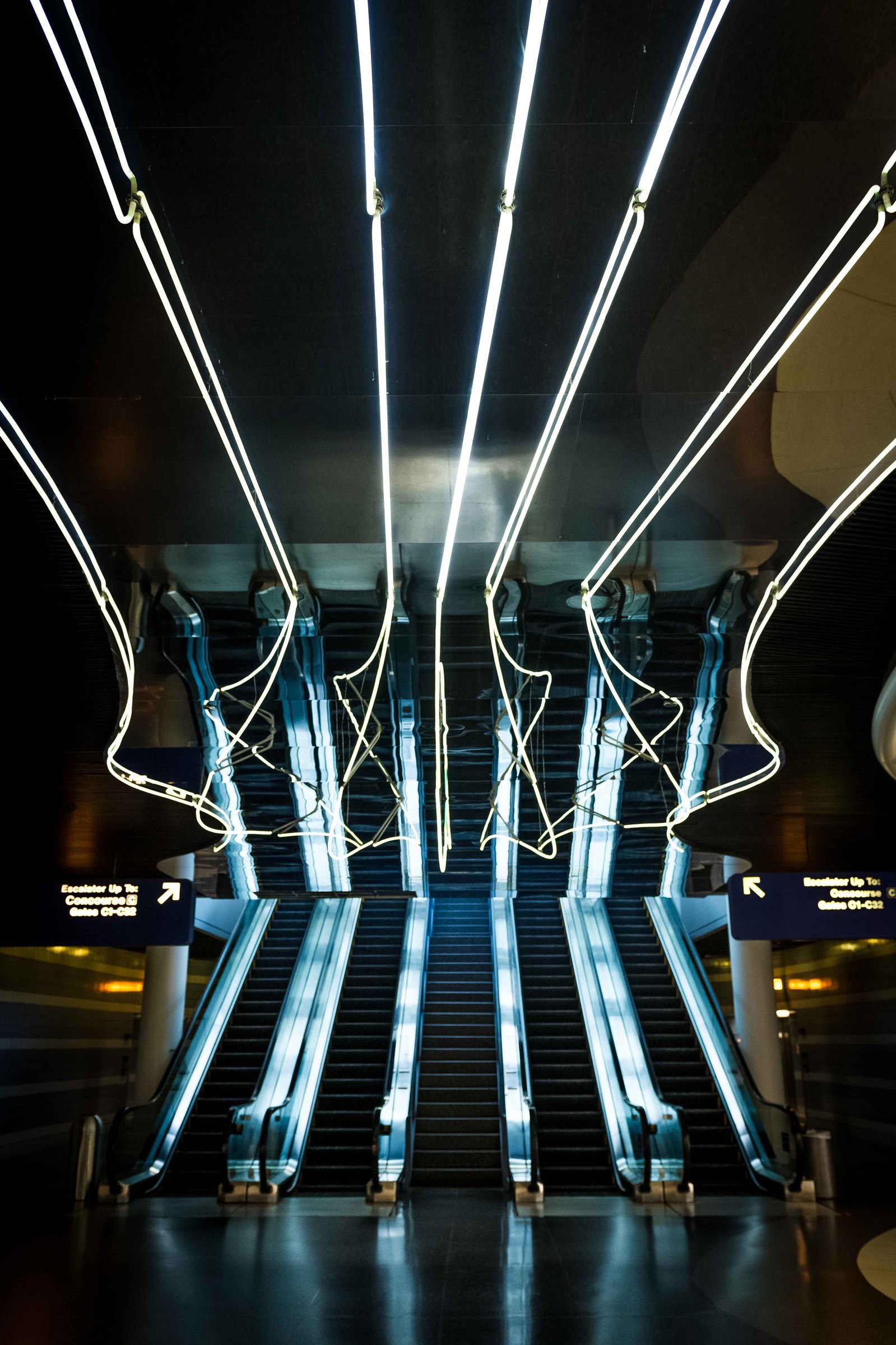 An image of an intricate high tech looking escalator at Chicago O'Hare's airport.