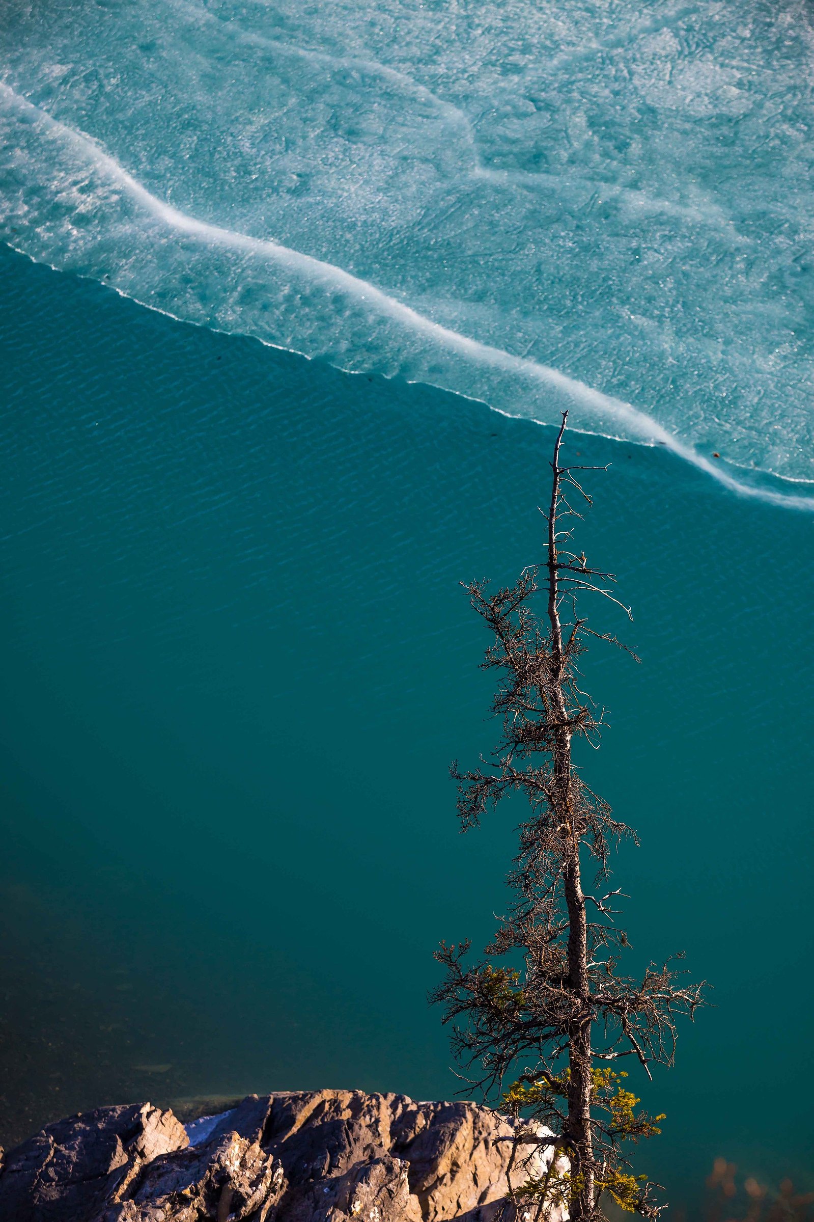 Looking down off of a high cliff and down into the frozen waters in Alaska.