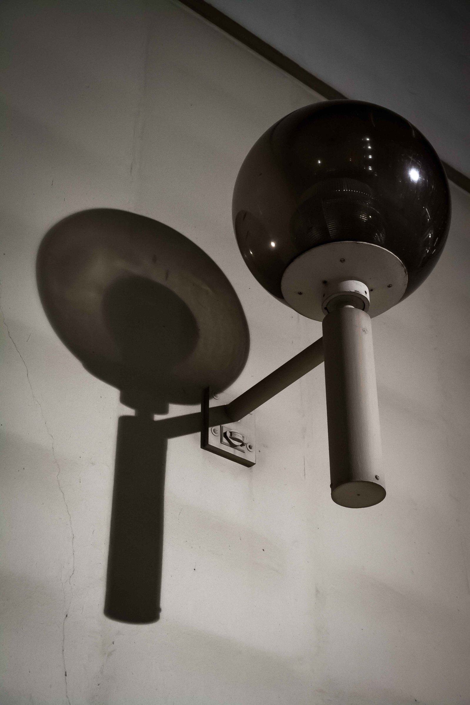 Looking at a street camera and the reflection it casts on the wall.